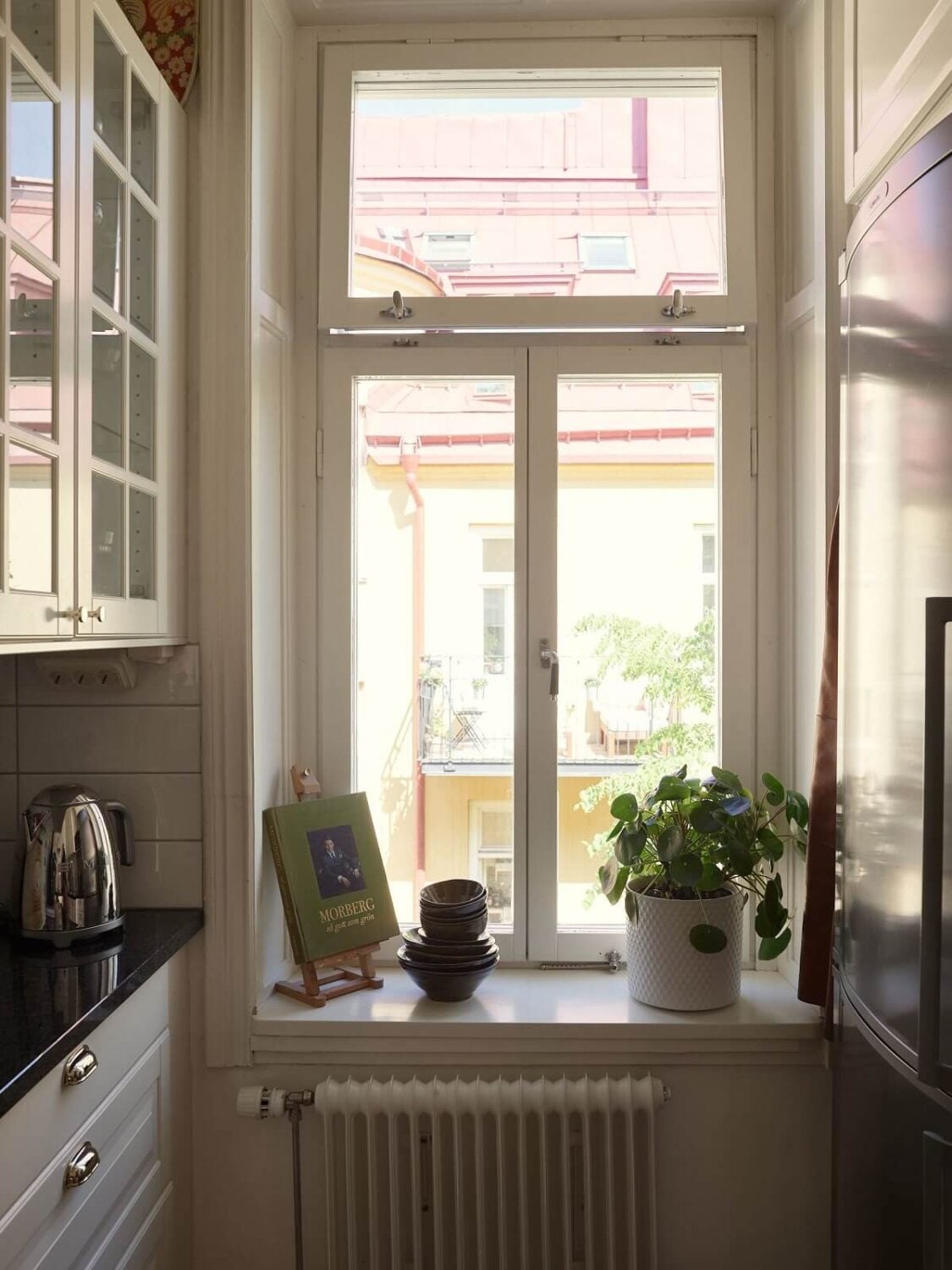 Period Features and Light Colors in a One-Bedroom Apartment 7 kitchen window