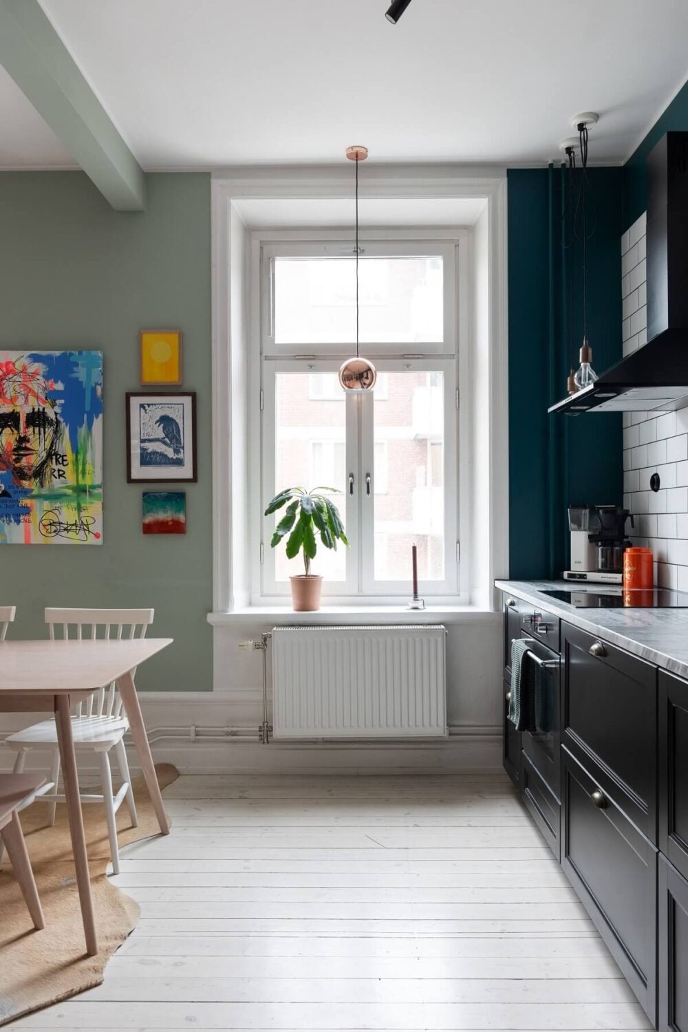 Colorful Art and Furniture in a Stylish Scandi Apartment 14 kitchen with black cabinets