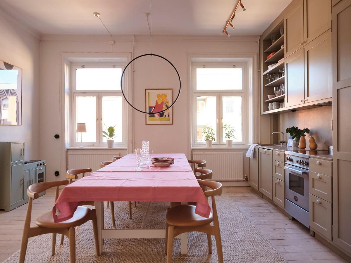 A Light Pastel Yellow and Pink Apartment in Stockholm 12 kitchen with large dining table