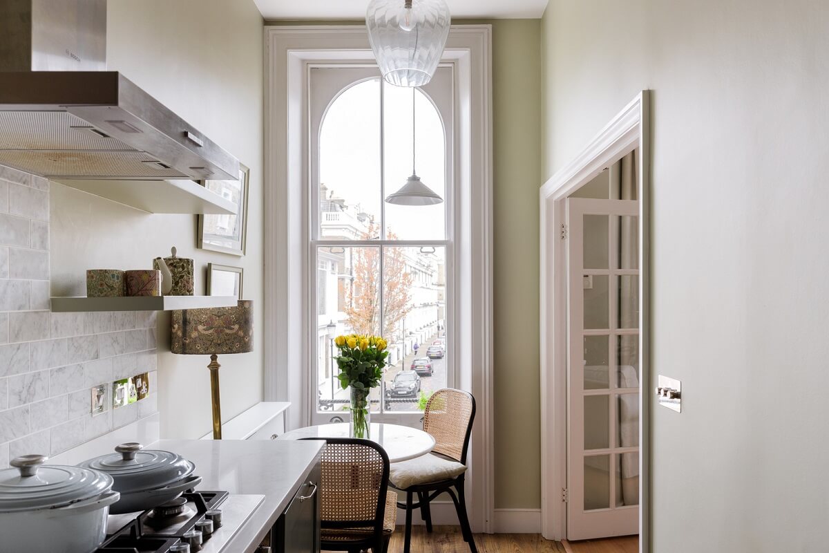 A Beautiful One-Bedroom Apartment with Plants and Period Features 7 kitchen with large window and tiny table