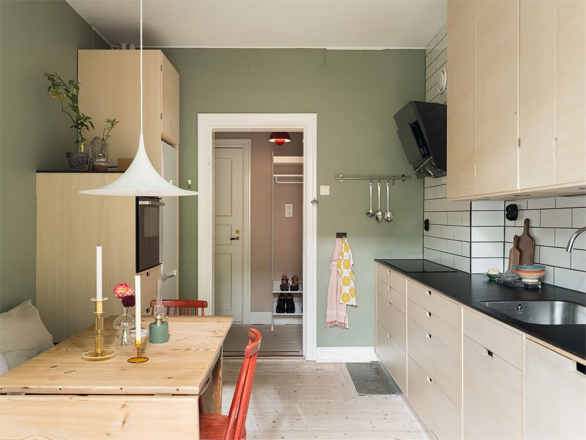 Colorful and Light Rooms in a Swedish One-Bedroom Apartment 12 kitchen with sage green walls
