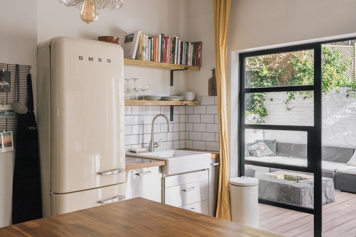 A Charming One-Bedroom Apartment with a Courtyard Terrace 4 kitchen with white tiles shelves and stainless steel cabinets