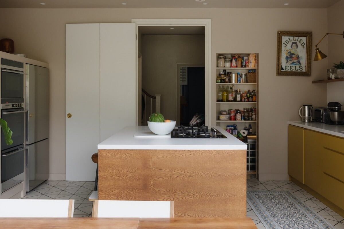 Nature-Inspired Colors in an Extended East London Home 4 kitchen with yellow cupboards and island