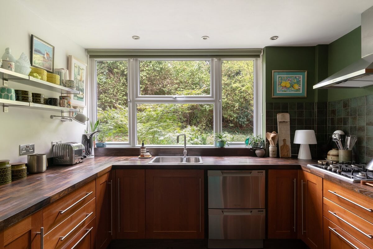 A Beautiful Mid-Century House in London 7 kitchen wooden cabinets green wall