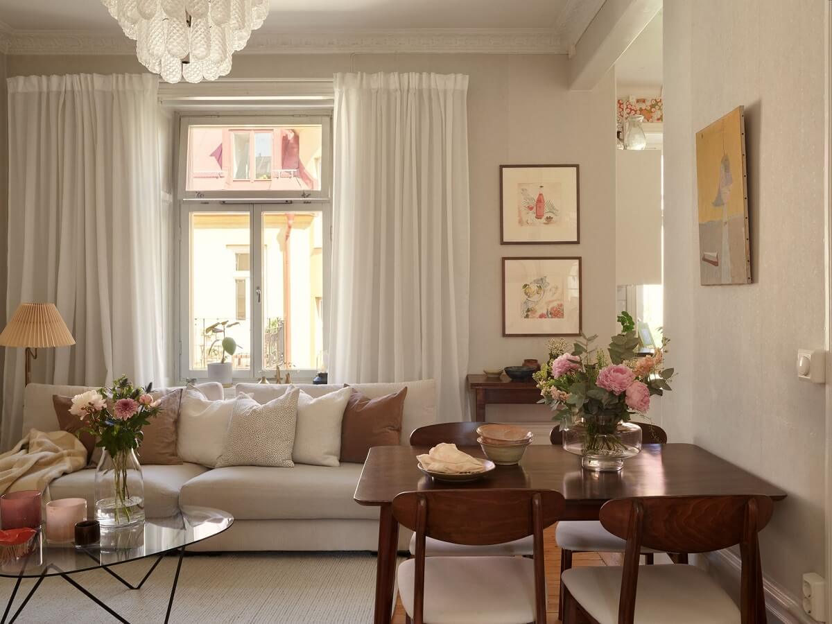 Period Features and Light Colors in a One-Bedroom Apartment 4 light colored living room with wooden table