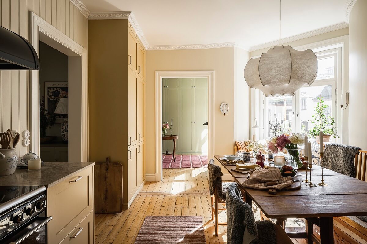 Hannes Mauritzson's Warm Yellow Hygge Apartment in Sweden 30 light filled kitchen yellow cabinets