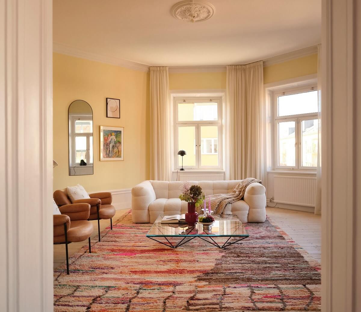 A Light Pastel Yellow and Pink Apartment in Stockholm 9 light yellow living room with large rug