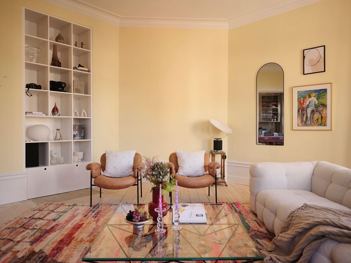 A Light Pastel Yellow and Pink Apartment in Stockholm 3 light yellow sitting room built in bookcase