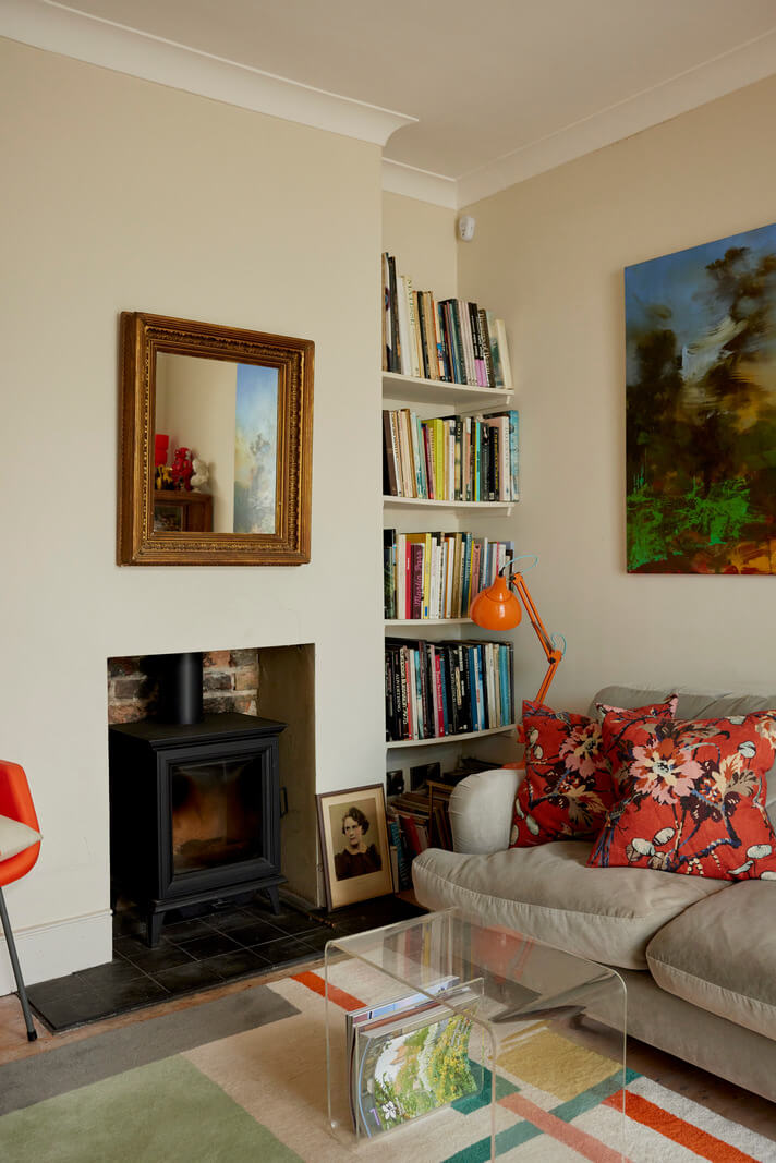 Muted Tones and an Orangery in a Victorian Coastal House 2 living room bookshelves wood burner