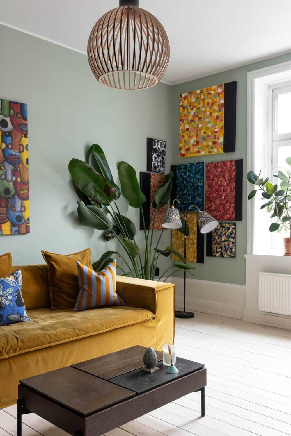 Colorful Art and Furniture in a Stylish Scandi Apartment 8 living room detail colorful art ochre sofa