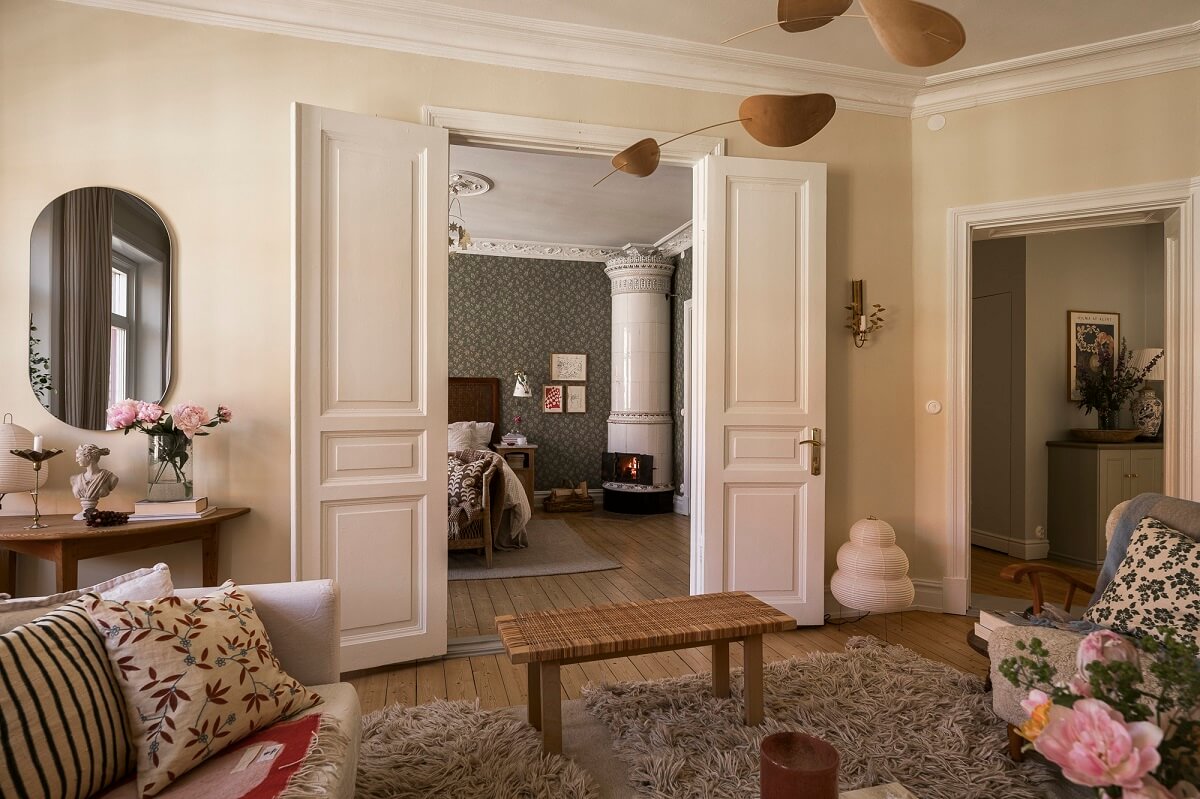 Hannes Mauritzson's Warm Yellow Hygge Apartment in Sweden 8 living room double doors to bedroom