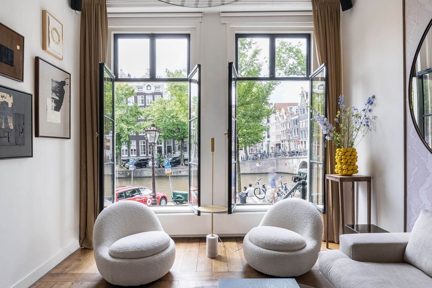 Hotel-Style Interiors in an Amsterdam Canal House 3 living room open windows amsterdam canal