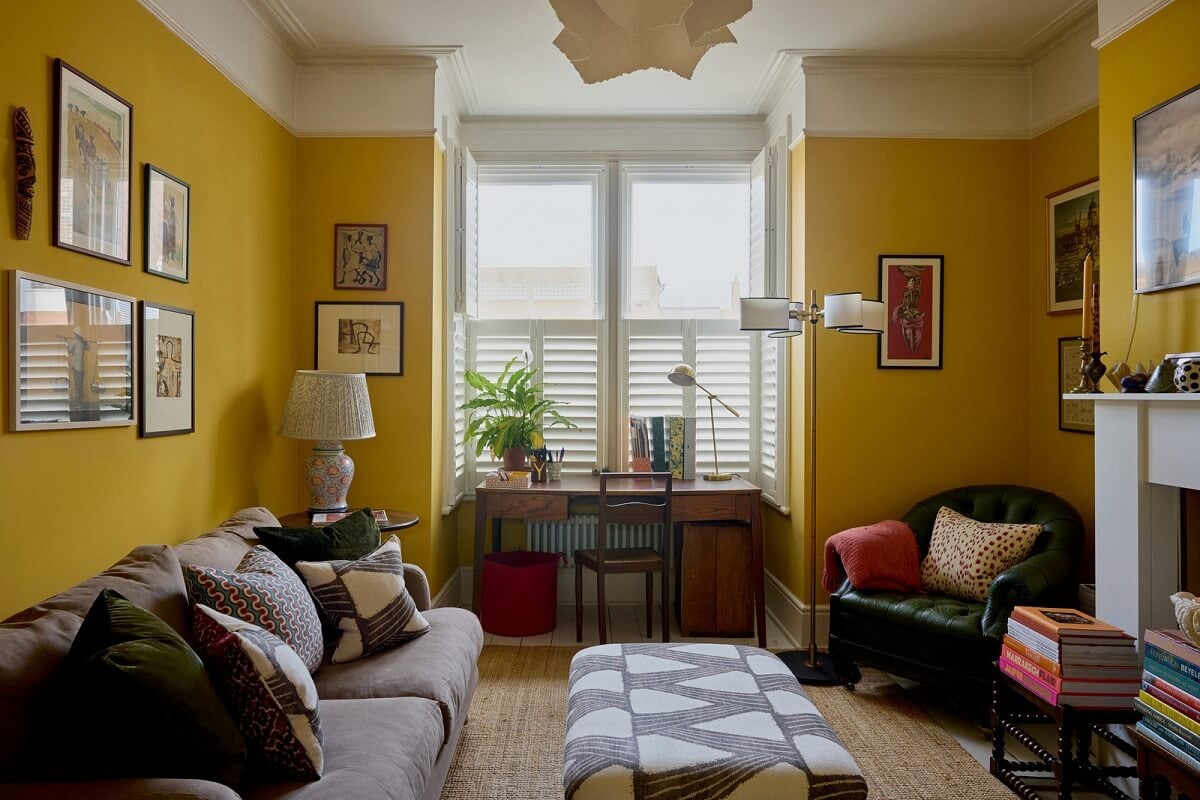living room with cheerful yellow walls bay window fireplace