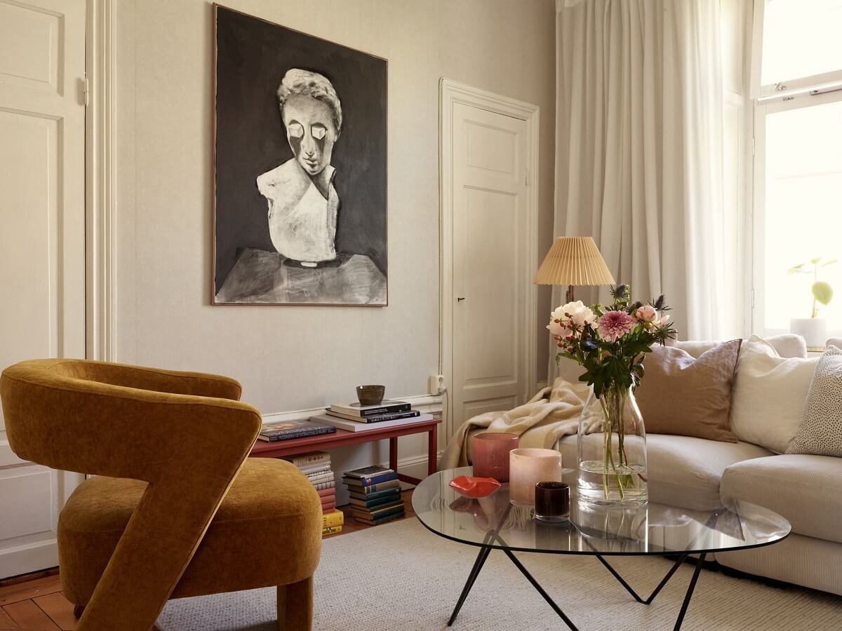 Period Features and Light Colors in a One-Bedroom Apartment 3 living room with ochre yellow chair and glass coffee table