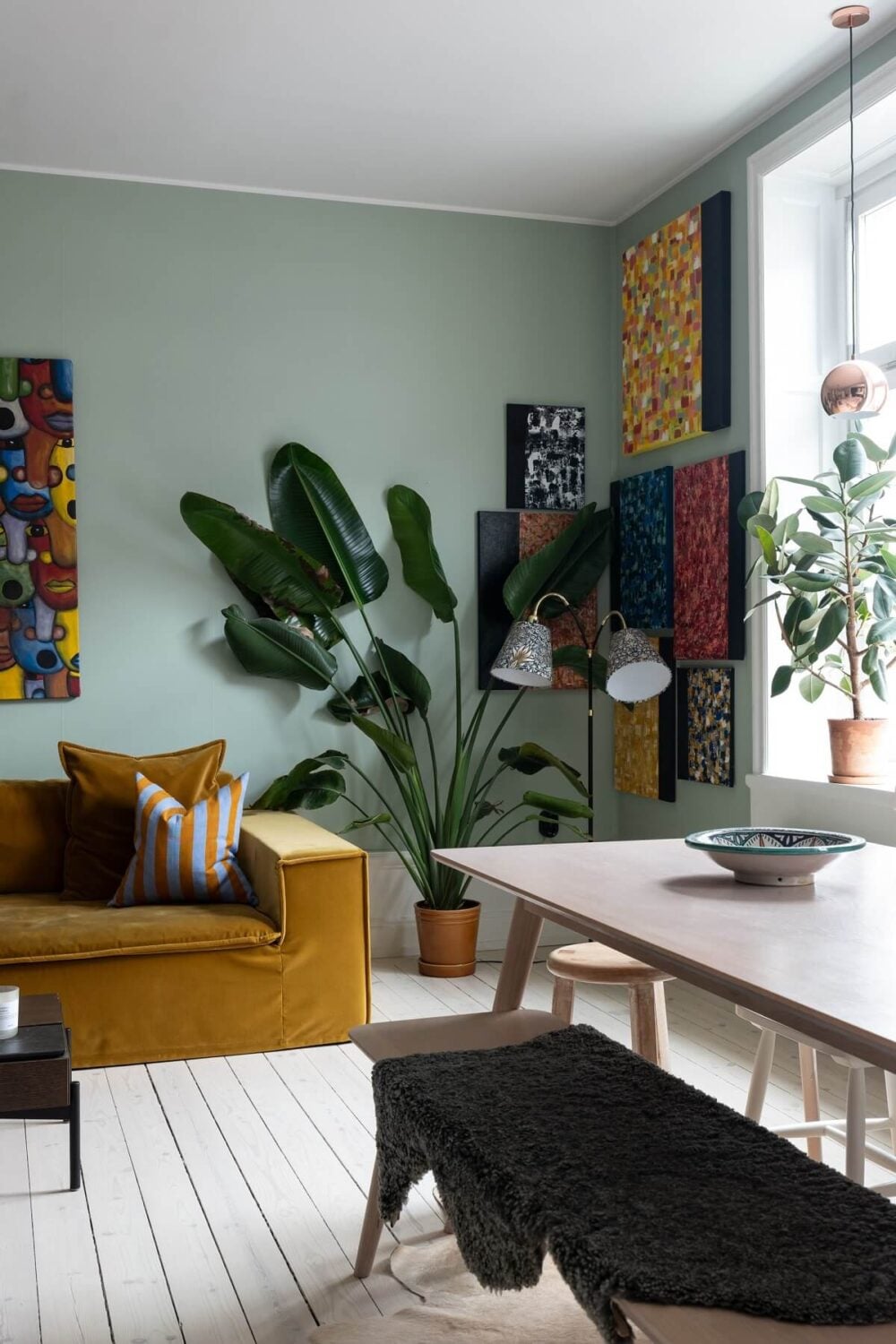 Colorful Art and Furniture in a Stylish Scandi Apartment 6 living room with plants and ochre yellow sofa nordroom