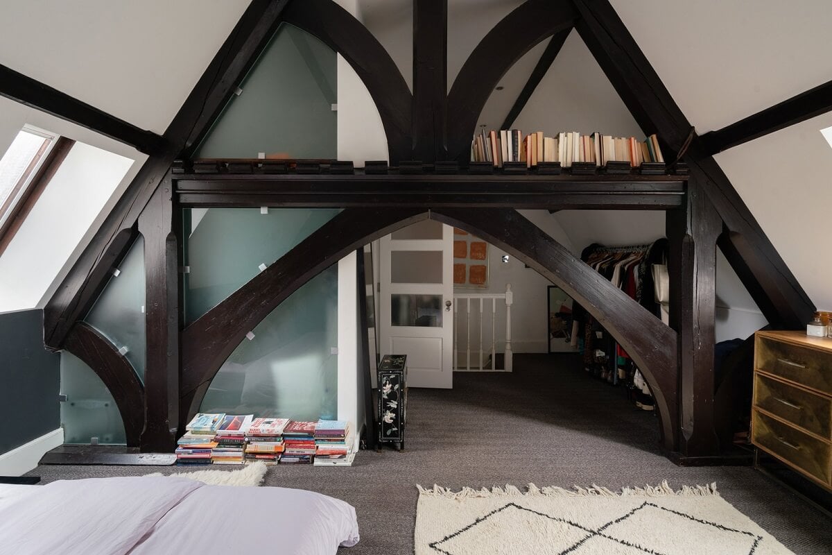 A Colorful Gothic-Style School Conversion in England 19 loft bedroom exposed wooden beams A Colorful Gothic-Style School Conversion in England