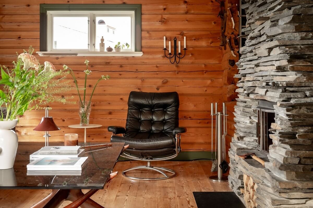 A Warm Scandinavian Log House with a Green Roof 4 log house living room stone fireplace