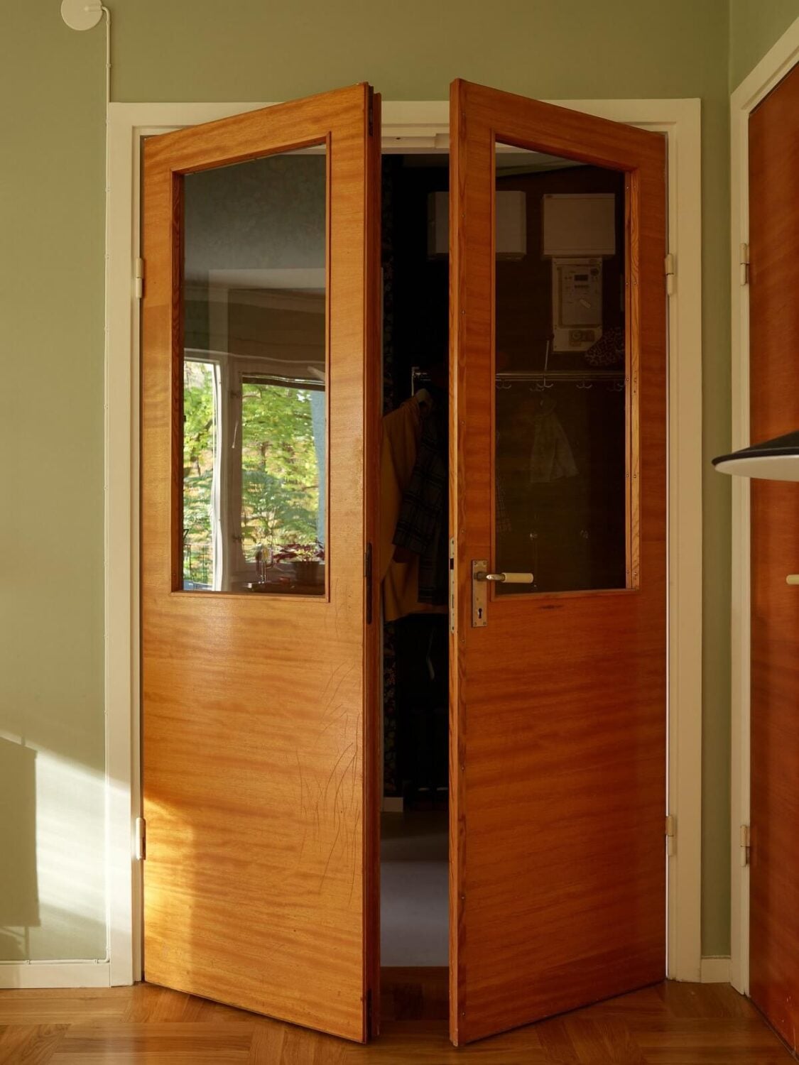 Preserved Midcentury Details and a Red Bedroom in a Stockholm Apartment 9 midcentury glass wood doors