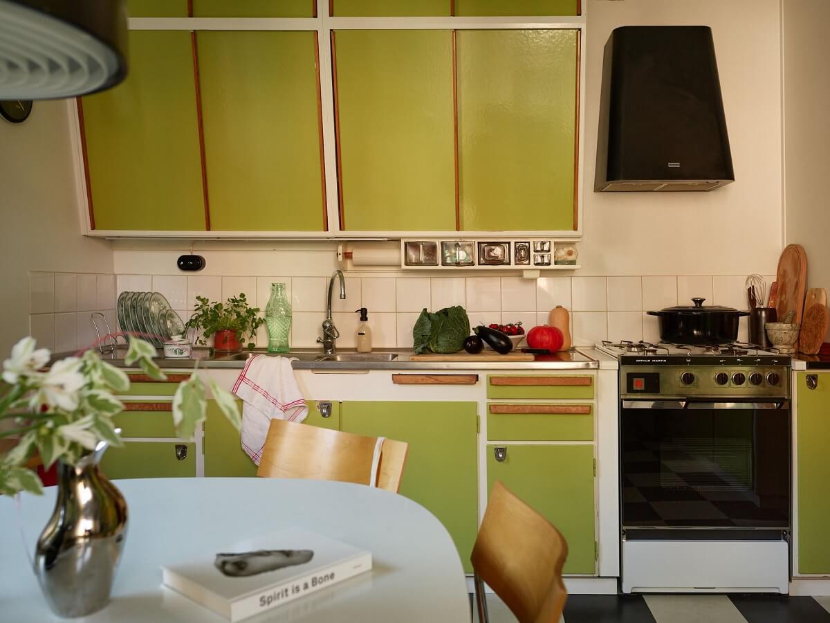 Preserved Midcentury Details and a Red Bedroom in a Stockholm Apartment 12 midcentury kitchen with green cabinets