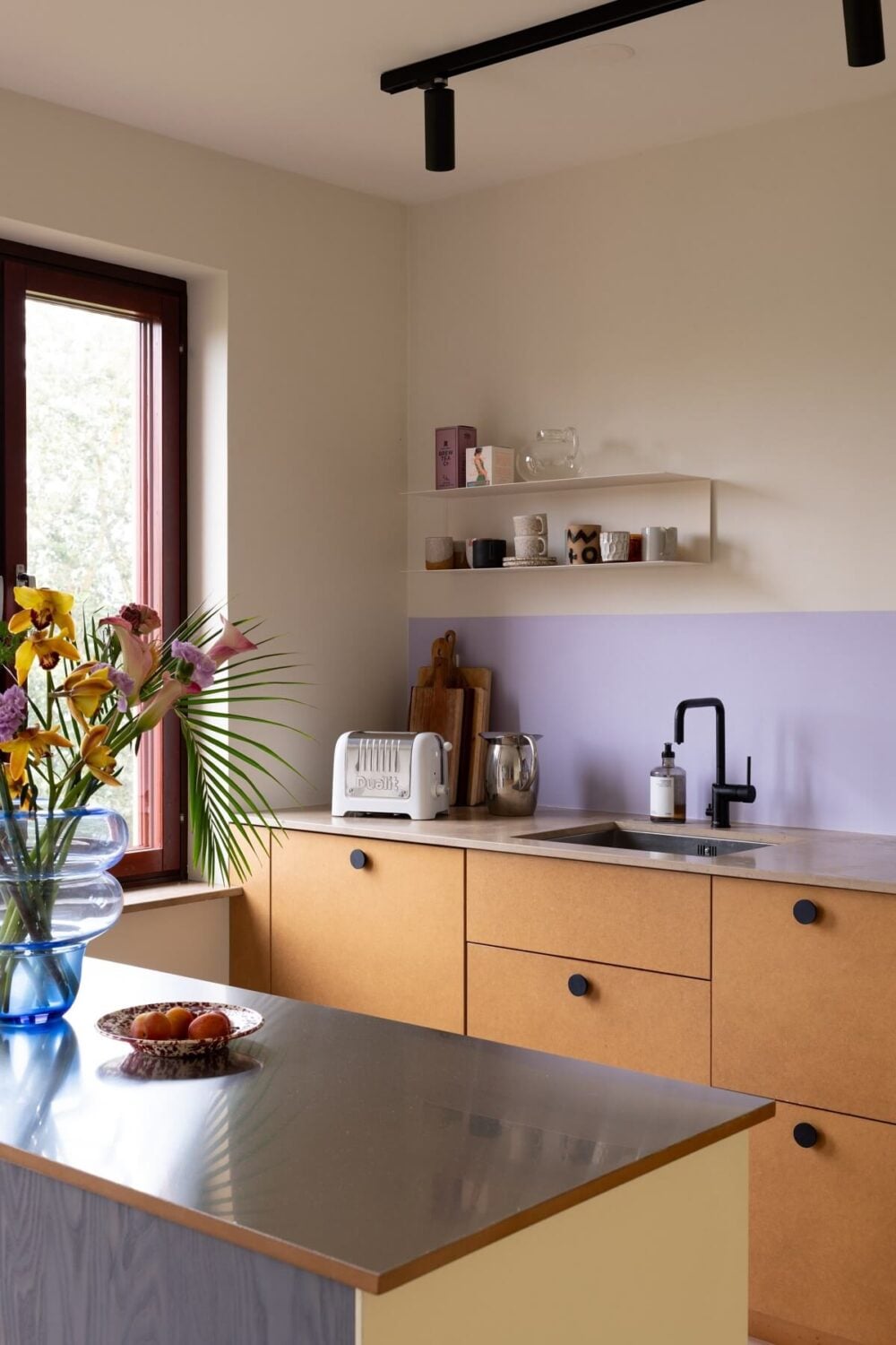A Light and Modern Stockholm Apartment with Cheerful Color Accents 4 modern kitchen lavender backsplash