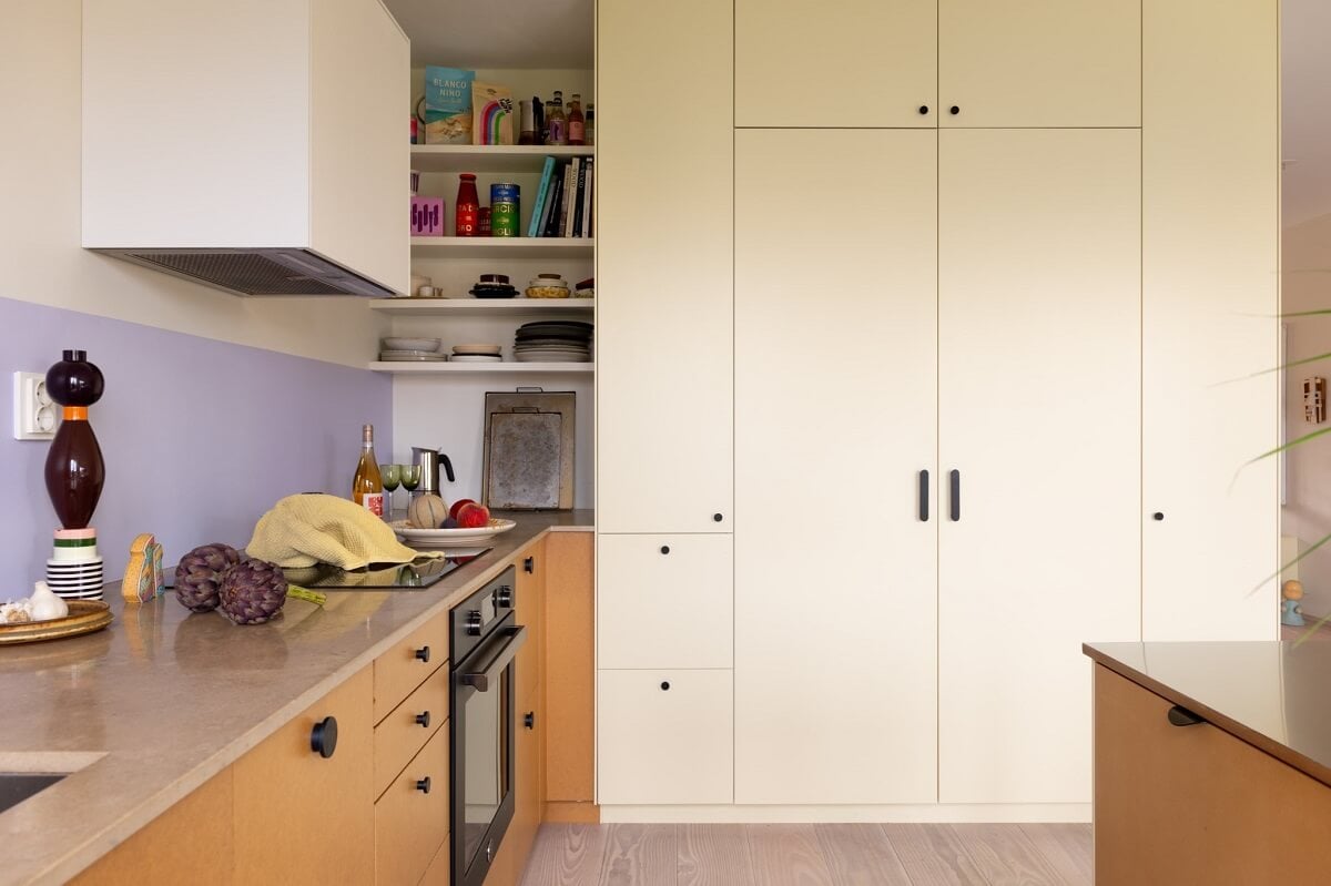 A Light and Modern Stockholm Apartment with Cheerful Color Accents 5 modern kitchen with white and wood cabinets