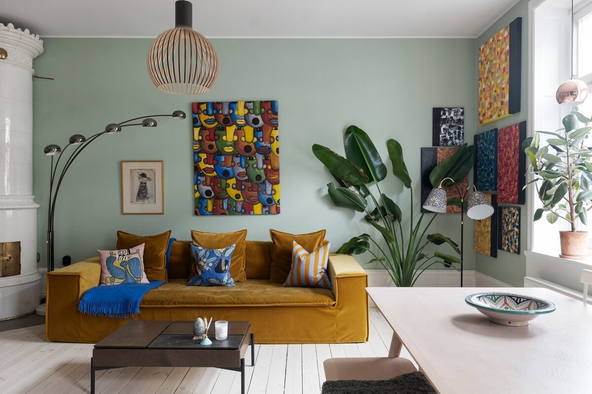 Colorful Art and Furniture in a Stylish Scandi Apartment 5 ochre sofa light green walls