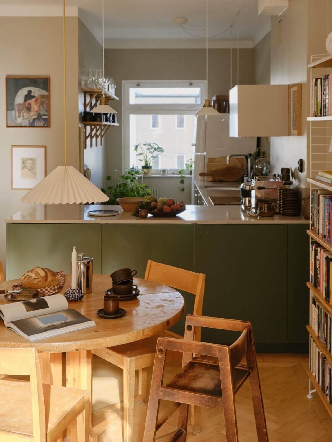 A Beautiful Calm and Natural Apartment with a Green Kitchen 7 open plan green kitchen and round dining table