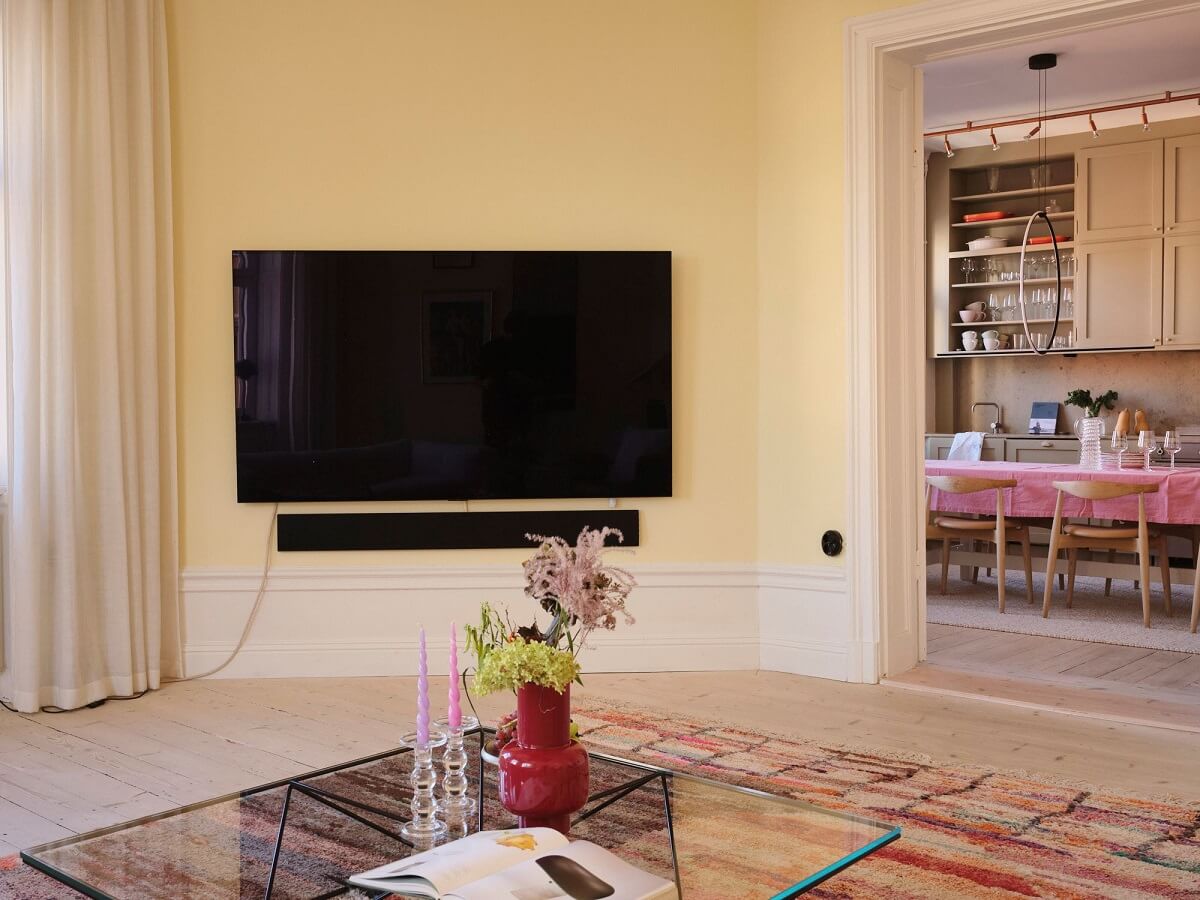 A Light Pastel Yellow and Pink Apartment in Stockholm 10 open plan living room kitchen