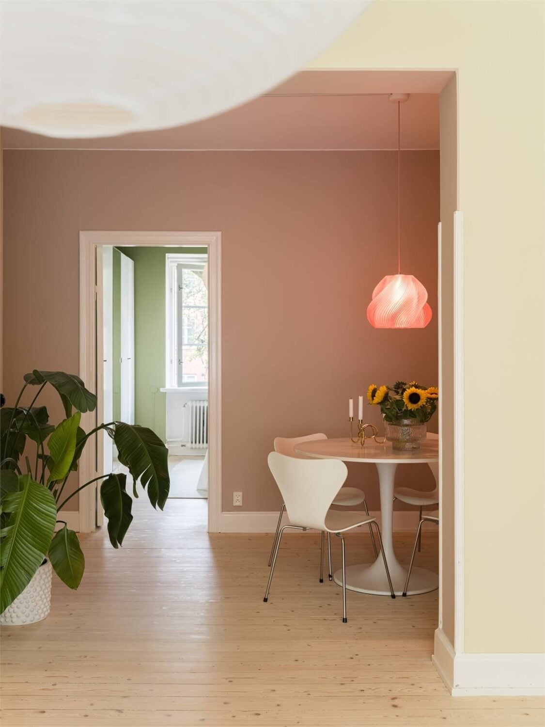 Colorful and Light Rooms in a Swedish One-Bedroom Apartment 5 pastel pink dining room with round table