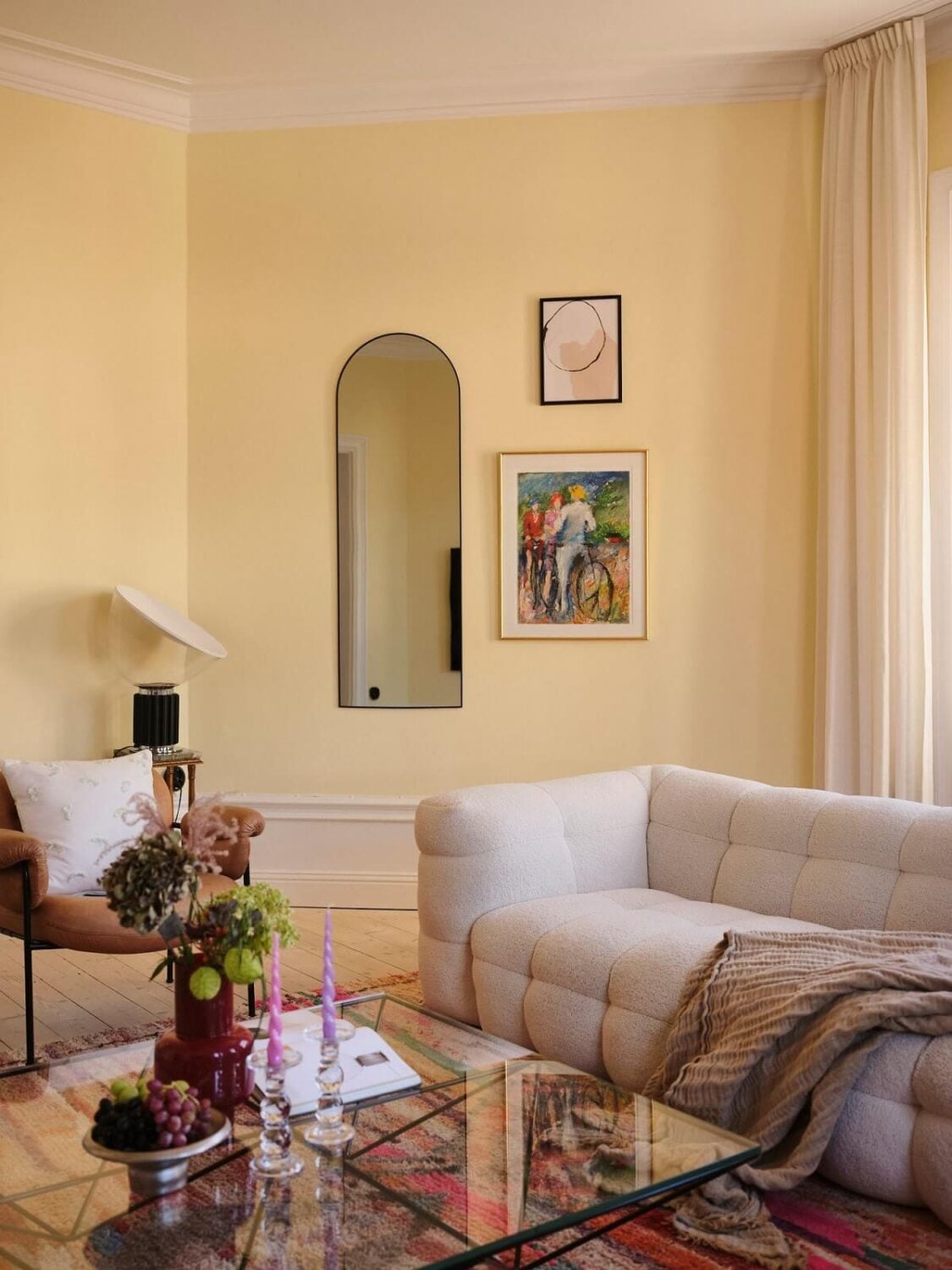 A Light Pastel Yellow and Pink Apartment in Stockholm 2 pastel yellow living room with arched niche nordroom