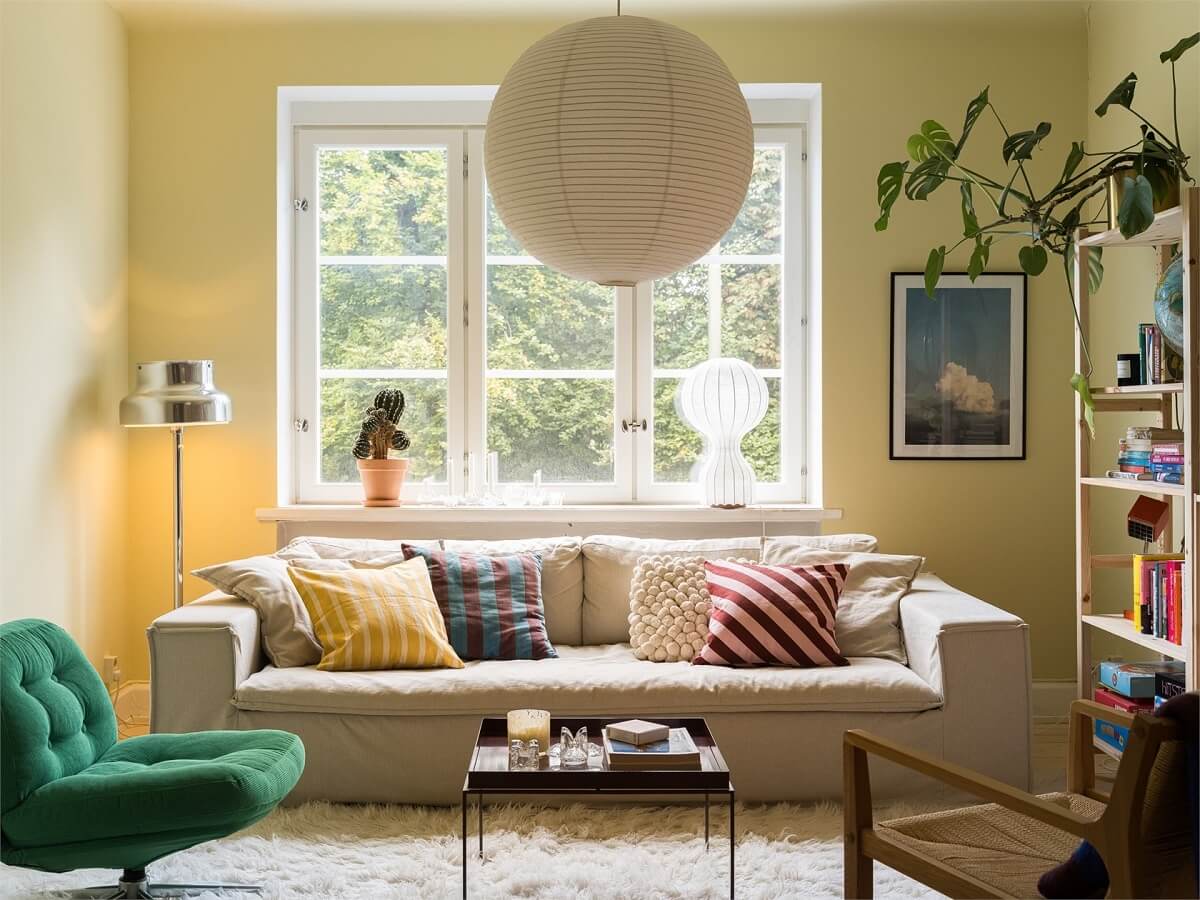 Colorful and Light Rooms in a Swedish One-Bedroom Apartment 2 pastel yellow living room