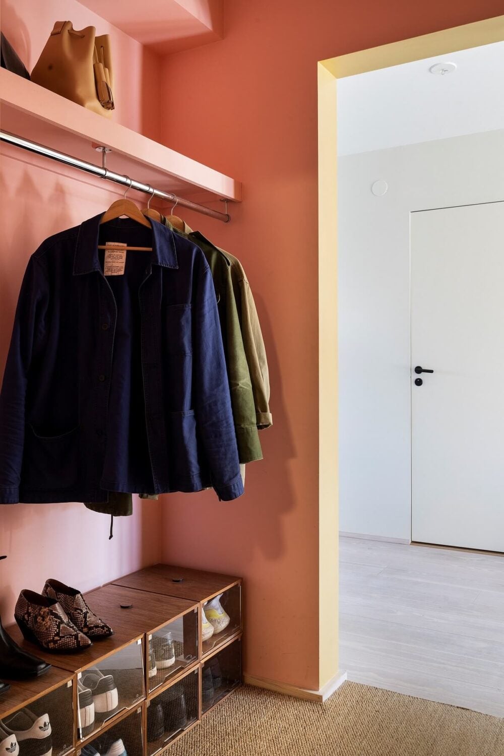 A Light and Modern Stockholm Apartment with Cheerful Color Accents 17 pink hallway