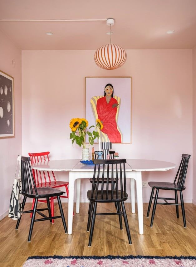 A Small, Colorful Attic Apartment with A Yellow Kitchen 7 pink living room with dining tabe