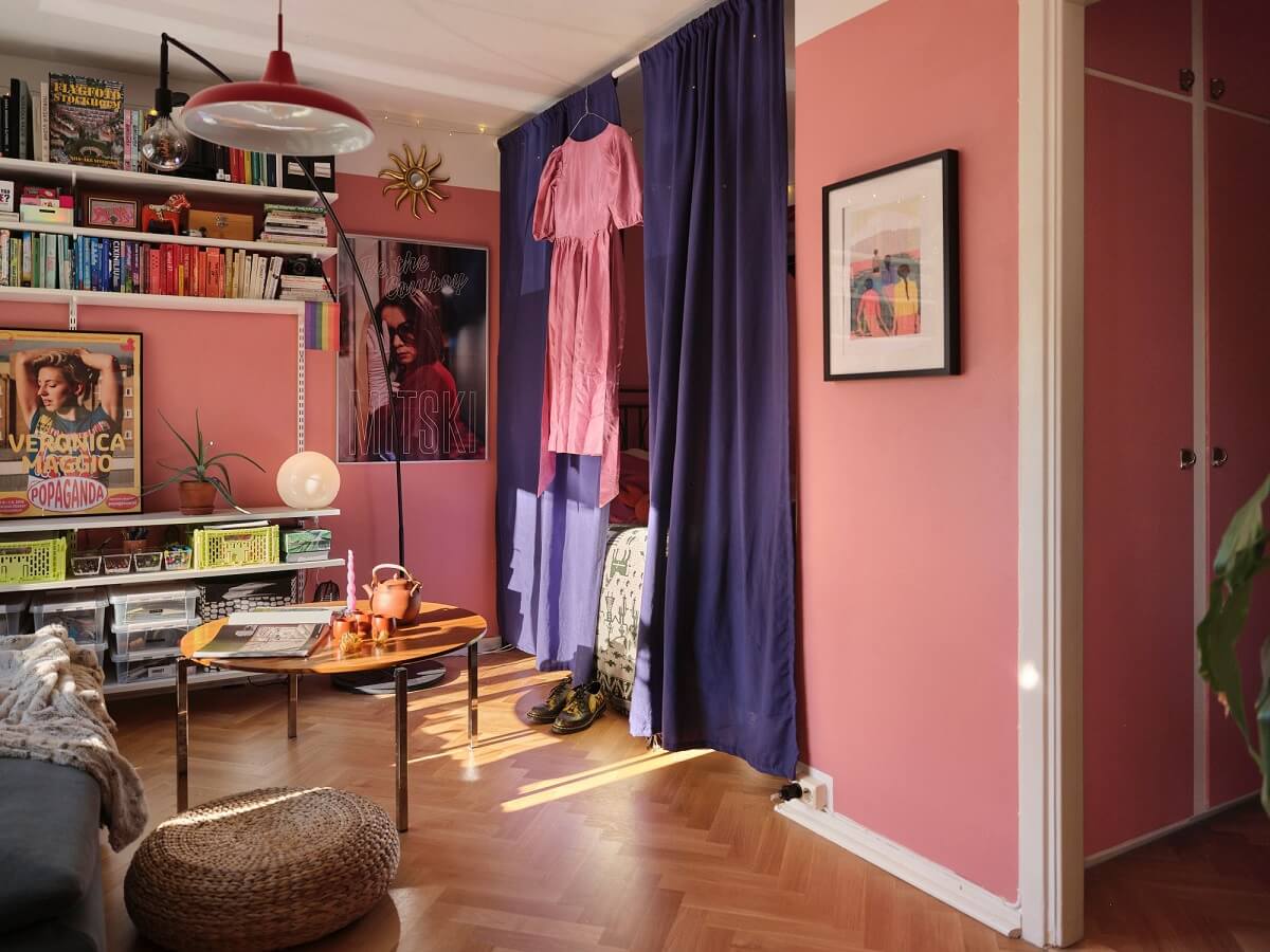 A Bold Pink Studio Apartment with a Light Yellow Kitchen 5 pink studio with purple curtains