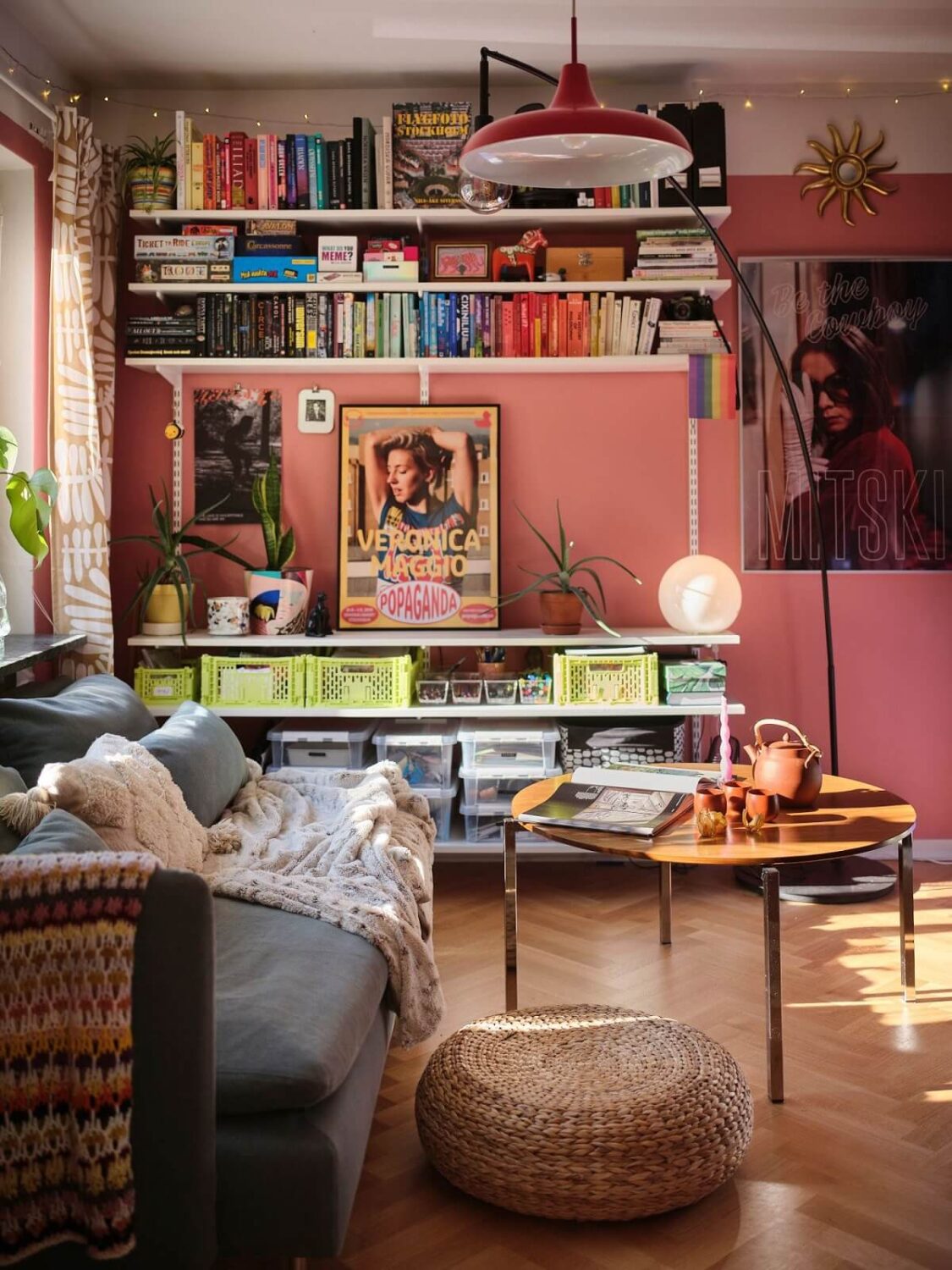 A Bold Pink Studio Apartment with a Light Yellow Kitchen 2 pink walls studio apartment with shelves and ikea sofa nordroom