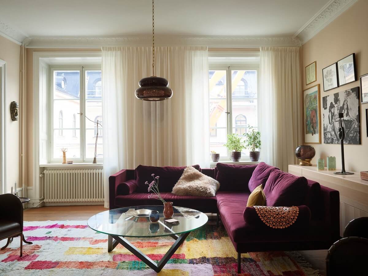 Beautiful Historic Details in a Large and Inviting Family Apartment 2 purple corner sofa and colorful rug