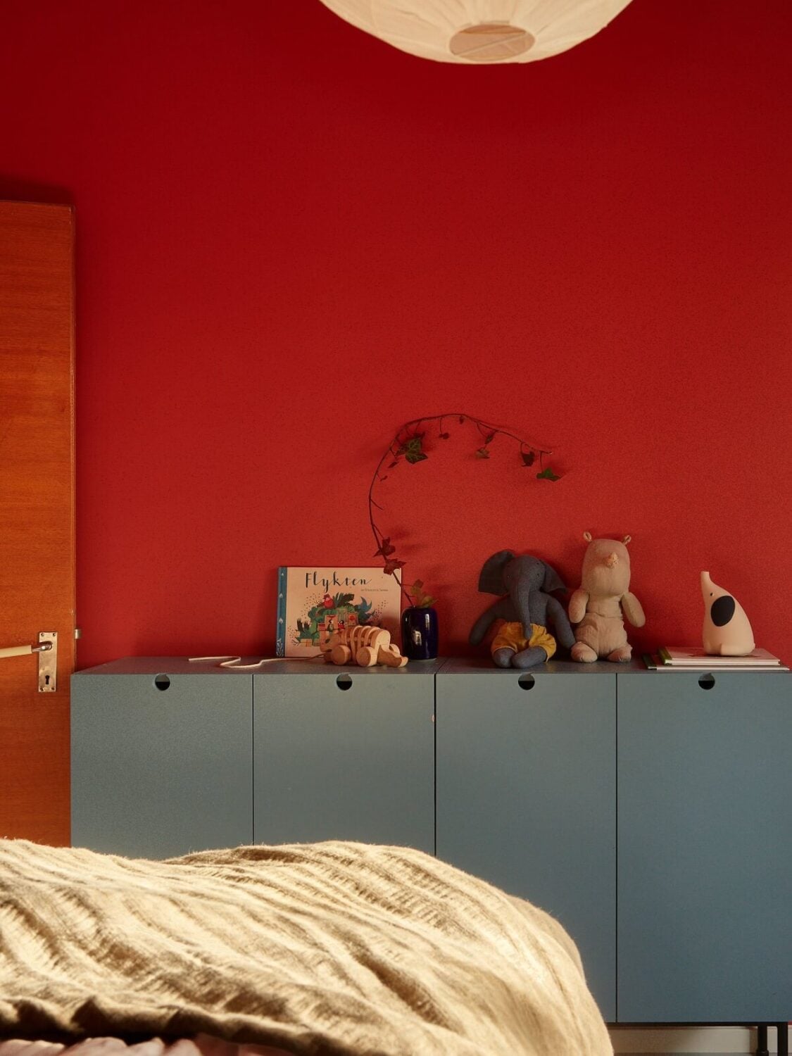 Preserved Midcentury Details and a Red Bedroom in a Stockholm Apartment 17 red bedroom with blue gray cabinets