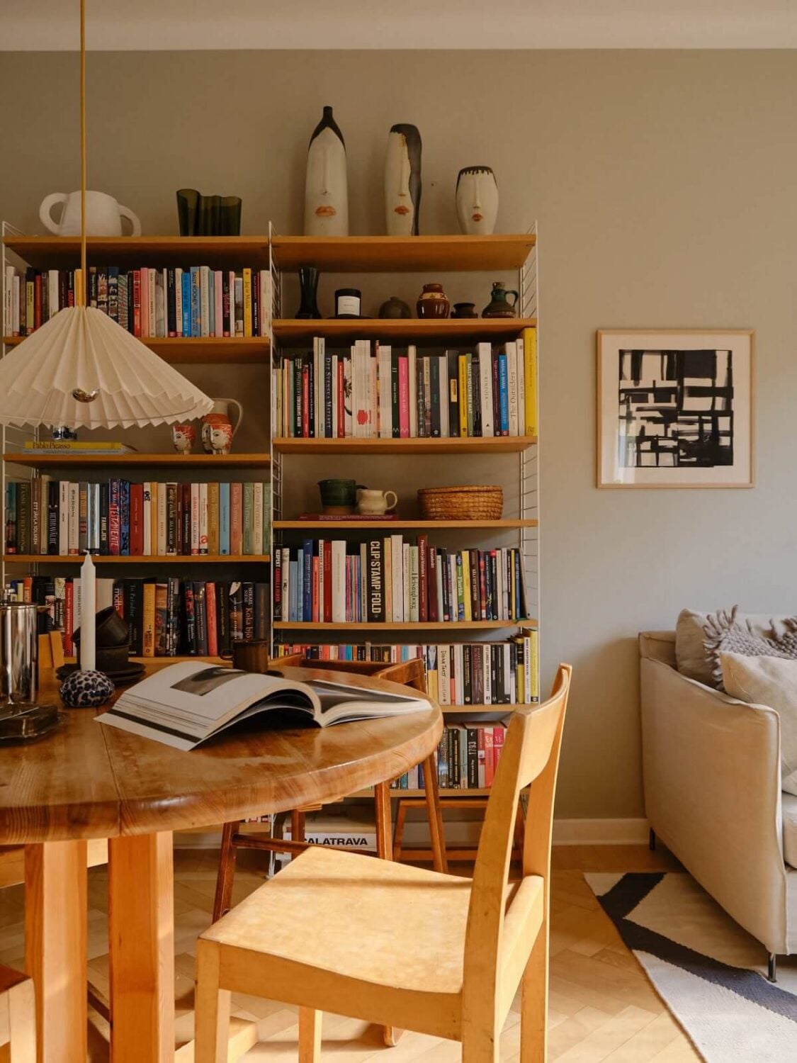 Best of 2024: Living Rooms 2 round dining table and bookshelves scandinavian living room
