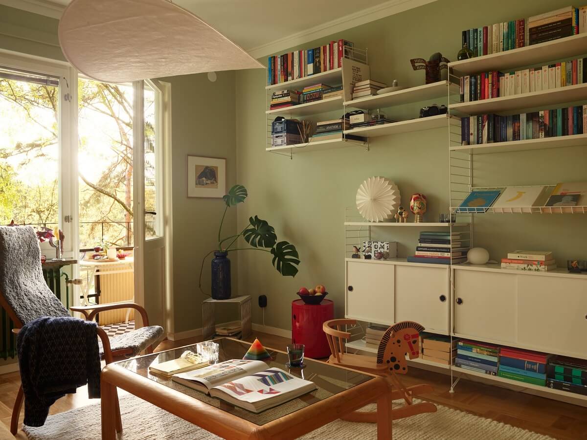 Preserved Midcentury Details and a Red Bedroom in a Stockholm Apartment 5 sage green walls living room