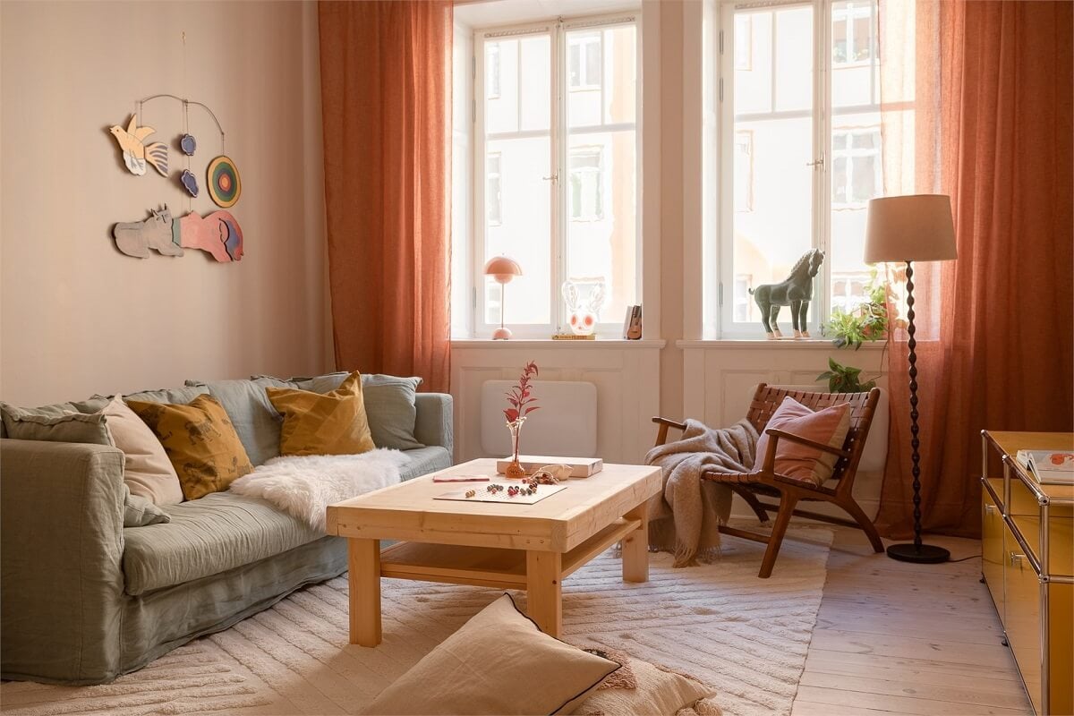 Nature-Inspired Colors in a Charming Stockholm Apartment 4 scandi living room wooden coffee table terracotta curtains