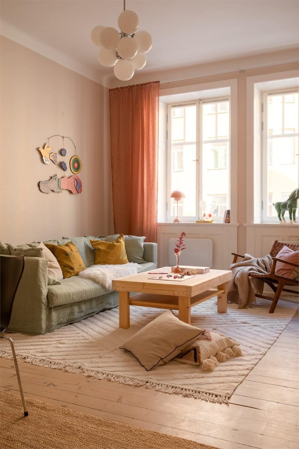 Nature-Inspired Colors in a Charming Stockholm Apartment 3 scandinavian living room terracotta curtains