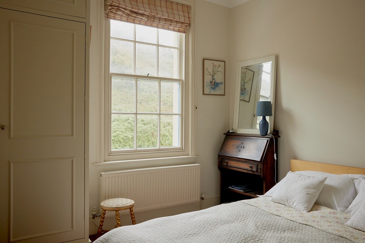 Muted Tones and an Orangery in a Victorian Coastal House 14 serene bedroom sash window
