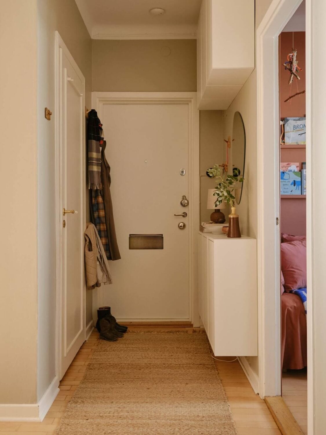 A Beautiful Calm and Natural Apartment with a Green Kitchen 23 small gray hallway with white storage cabinet