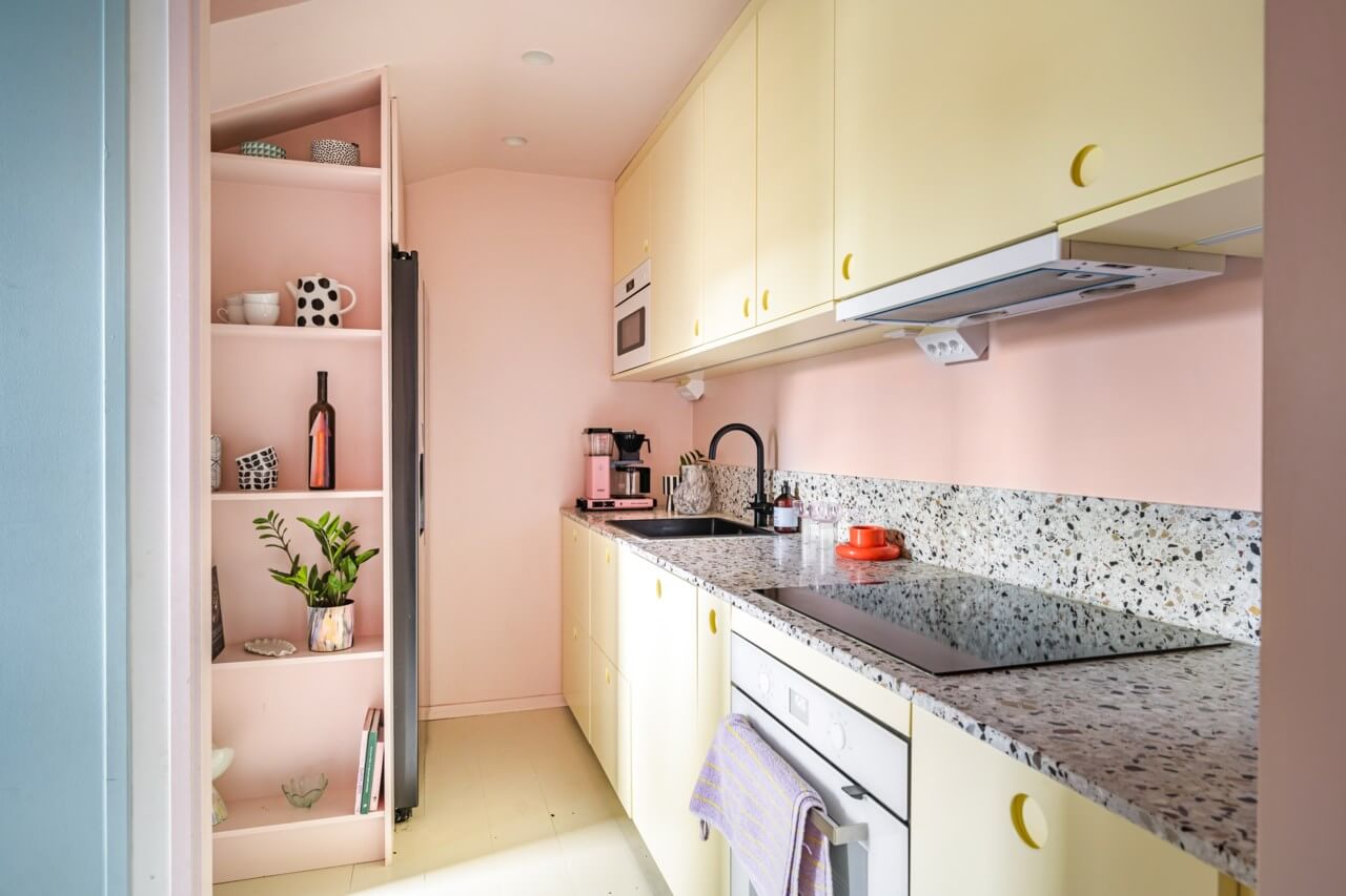 A Small, Colorful Attic Apartment with A Yellow Kitchen 13 small kitchen lught yellow cabinets