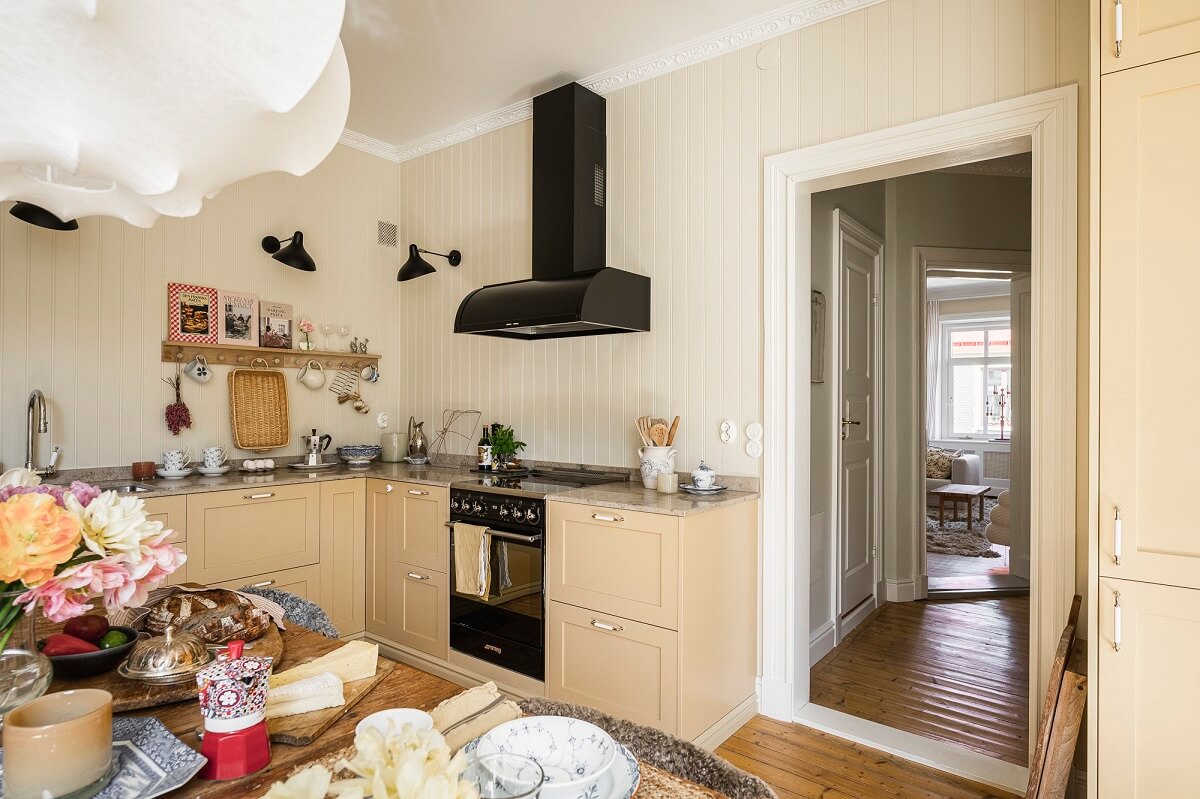 Hannes Mauritzson's Warm Yellow Hygge Apartment in Sweden 26 soft yellow kitchen