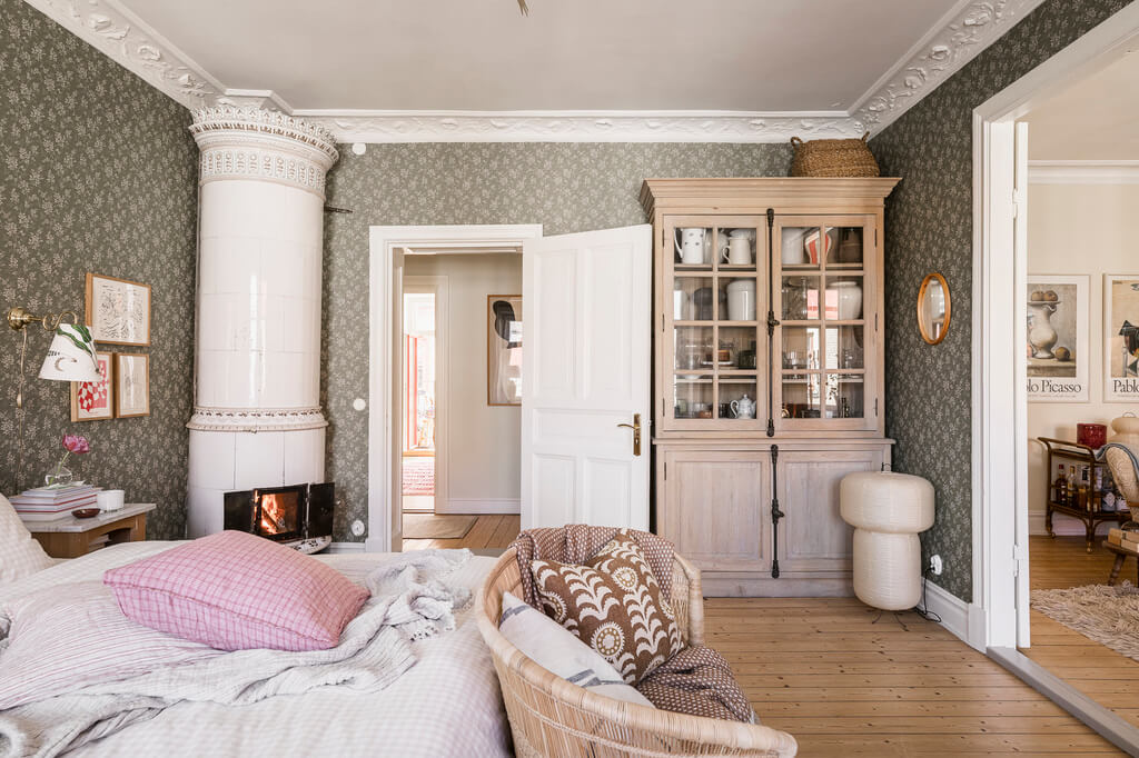 Hannes Mauritzson's Warm Yellow Hygge Apartment in Sweden 15 spacious bedroom wooden floor fireplace Hip Rose wallpaper