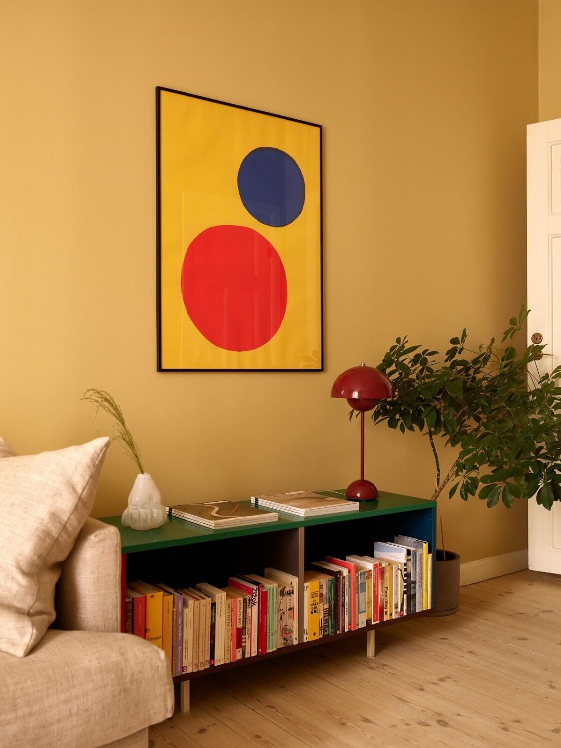 Golden Yellow Walls in a Colorful Swedish Studio Apartment 4 studio green bookcase golden yellow walls nordroom