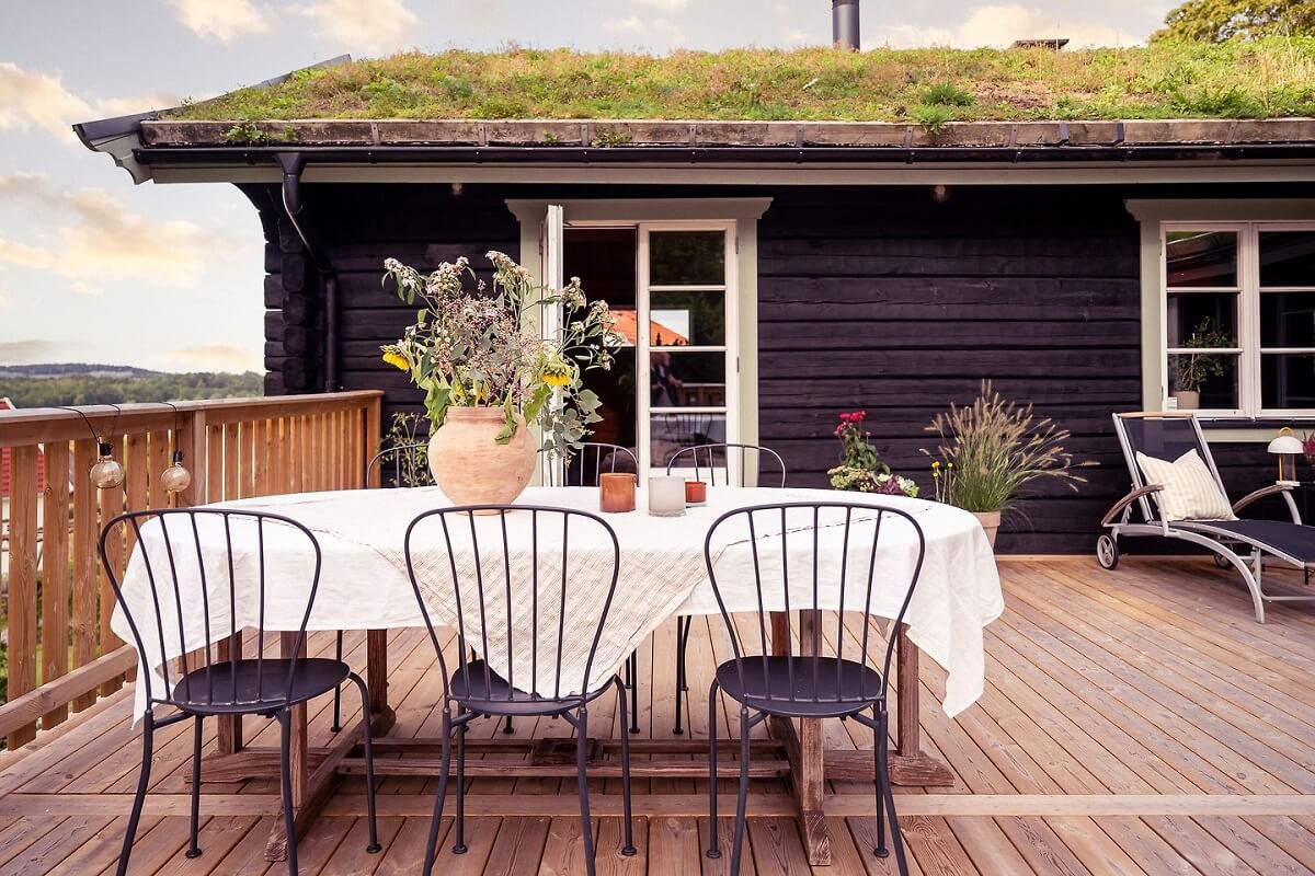 A Warm Scandinavian Log House with a Green Roof 25 terrace log house green roof