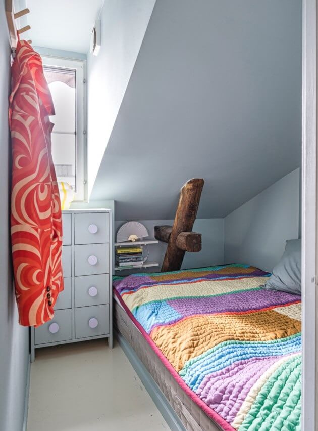 A Small, Colorful Attic Apartment with A Yellow Kitchen 19 tiny bedroom slanted ceiling