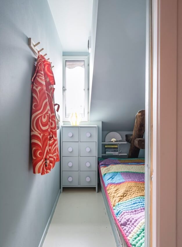 A Small, Colorful Attic Apartment with A Yellow Kitchen 18 tiny bedroom